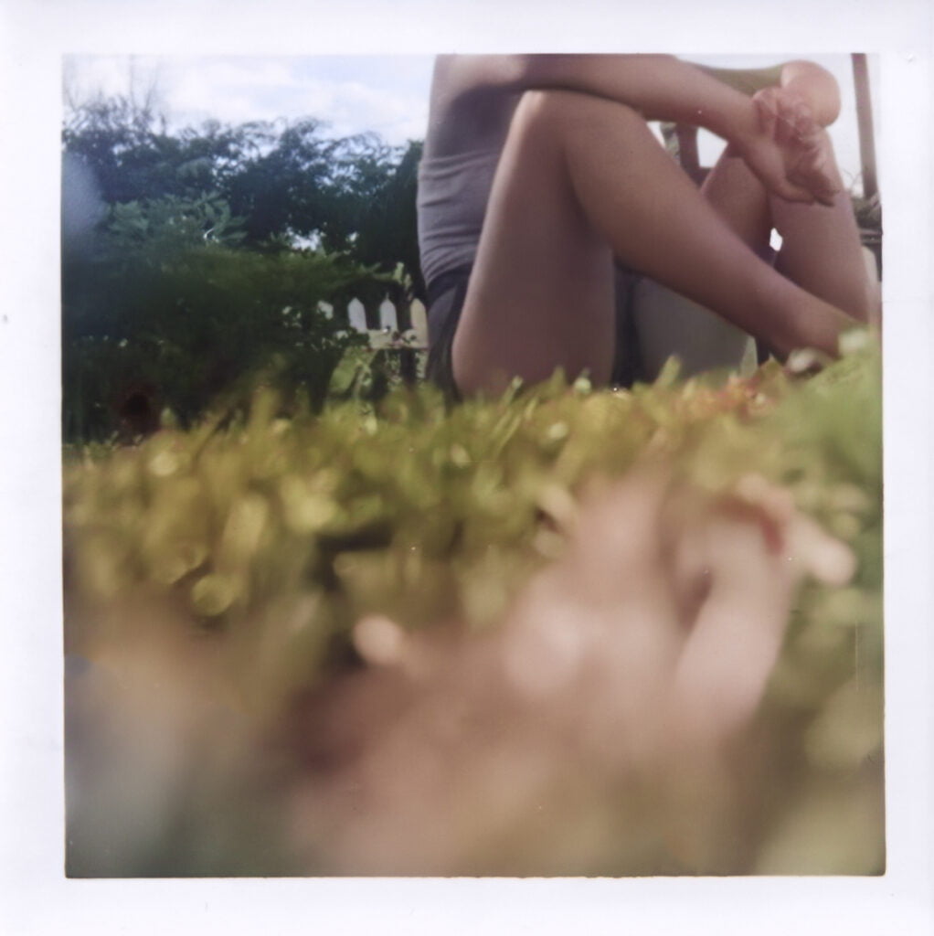 This is the first image I ever captured! It shows our neighbour sitting on the grass in Grand Mere, PQ; her head is cut off at the frame border. Taken on a Kodak Brownie Hawkeye.